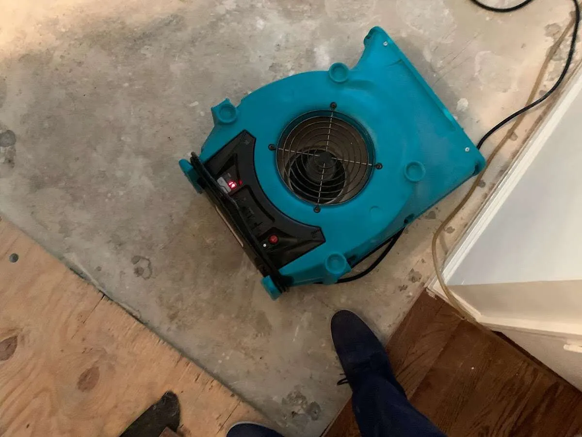 Air mover drying subfloor during Commercial Water Damage Restoration in Pittsburg